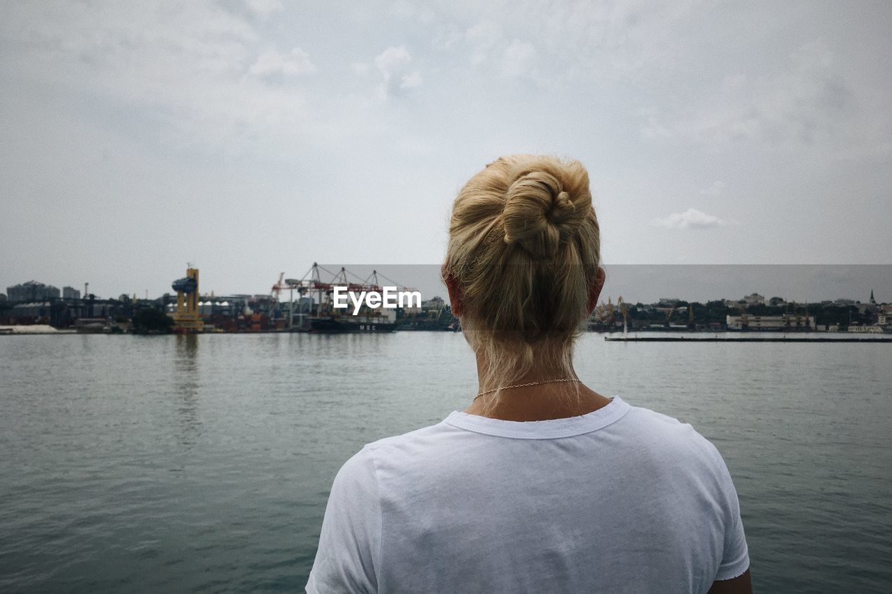 Woman looks at the odessa port. photo from the back