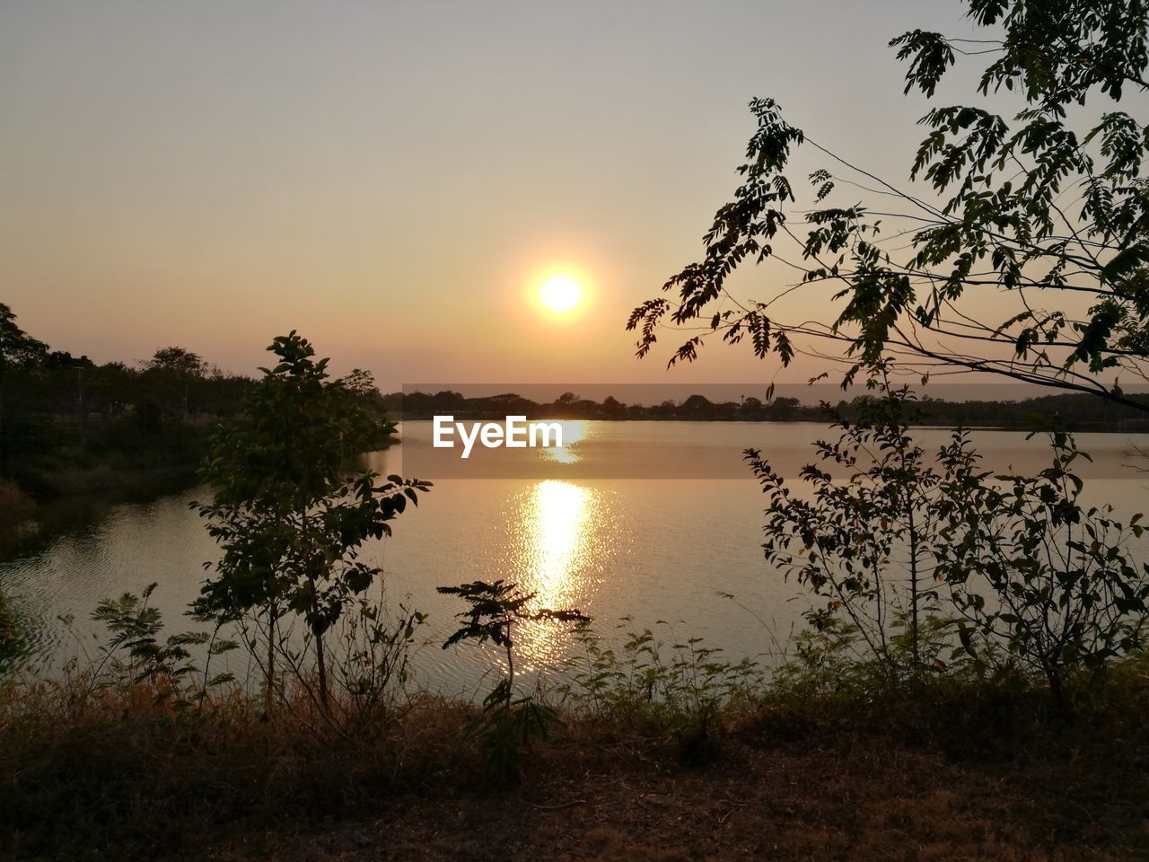 SCENIC VIEW OF LAKE DURING SUNSET