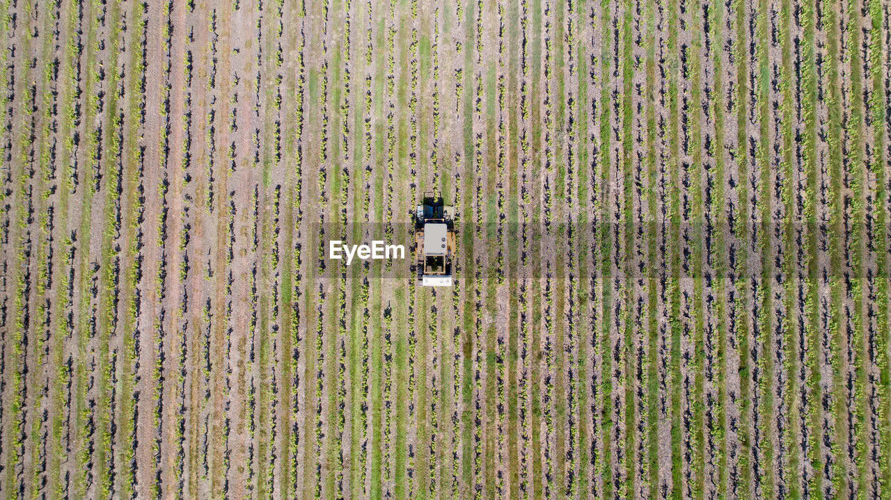 Aerial view of agricultural machinery working on farm