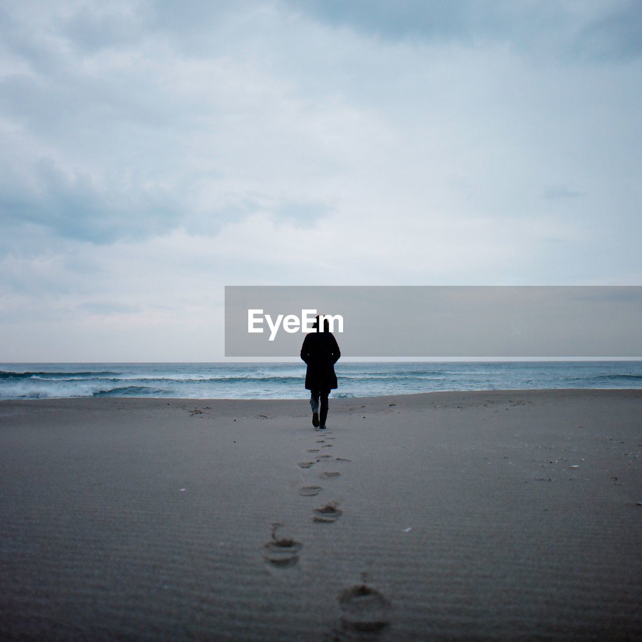 Rear view of a woman walking on beach