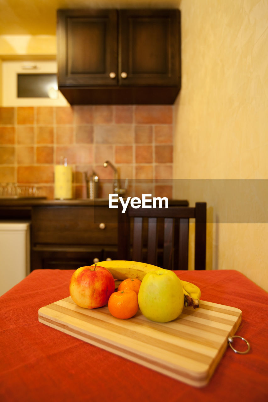 FRUITS AND VEGETABLES ON CUTTING BOARD