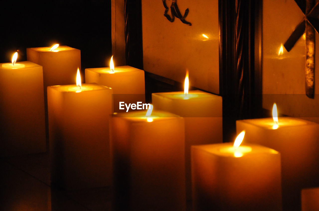 close-up of illuminated candles on table