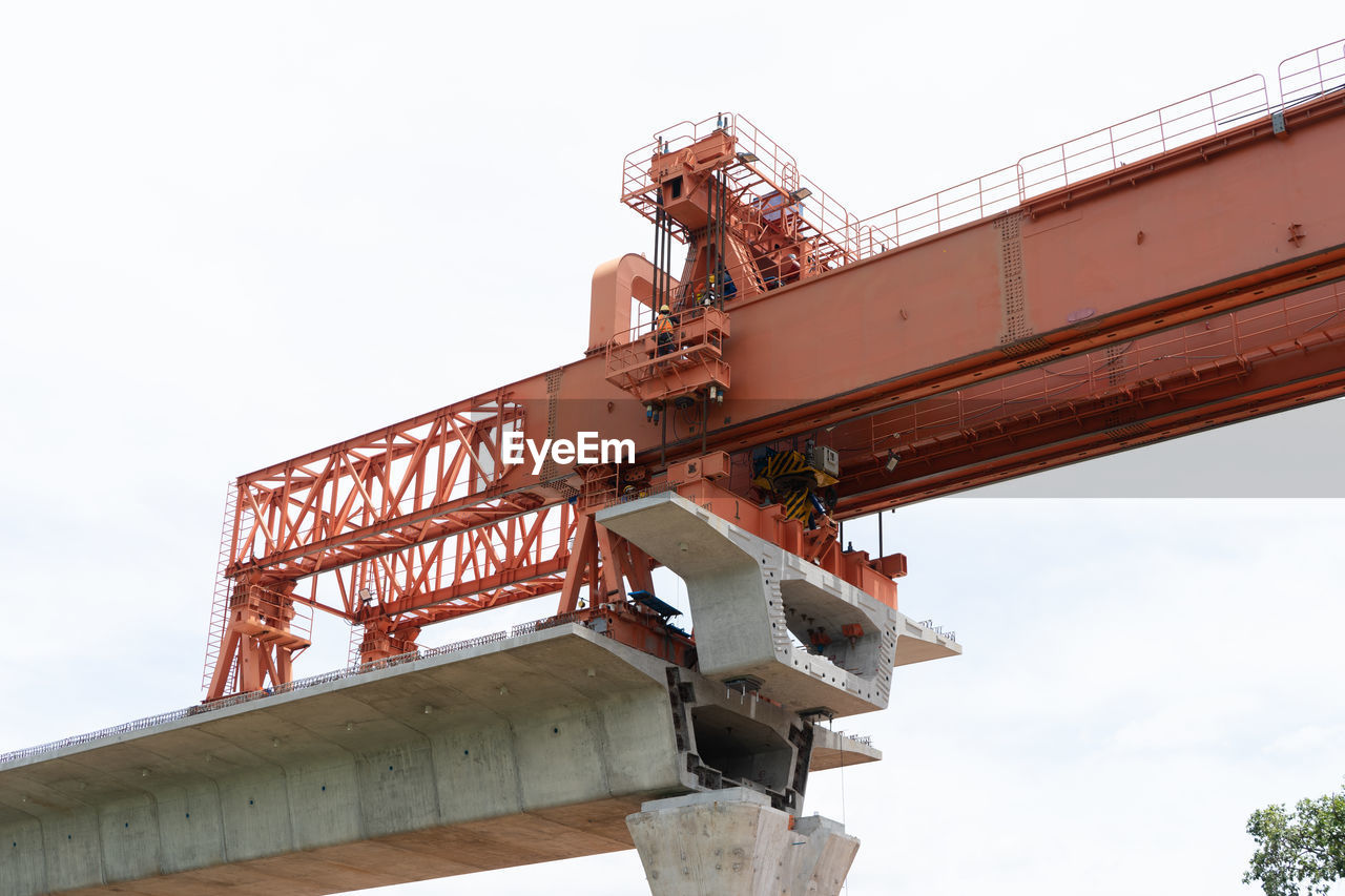 industry, architecture, sky, machinery, crane - construction machinery, construction equipment, vehicle, nature, business, transportation, low angle view, transport, built structure, business finance and industry, outdoors, construction industry, day, no people
