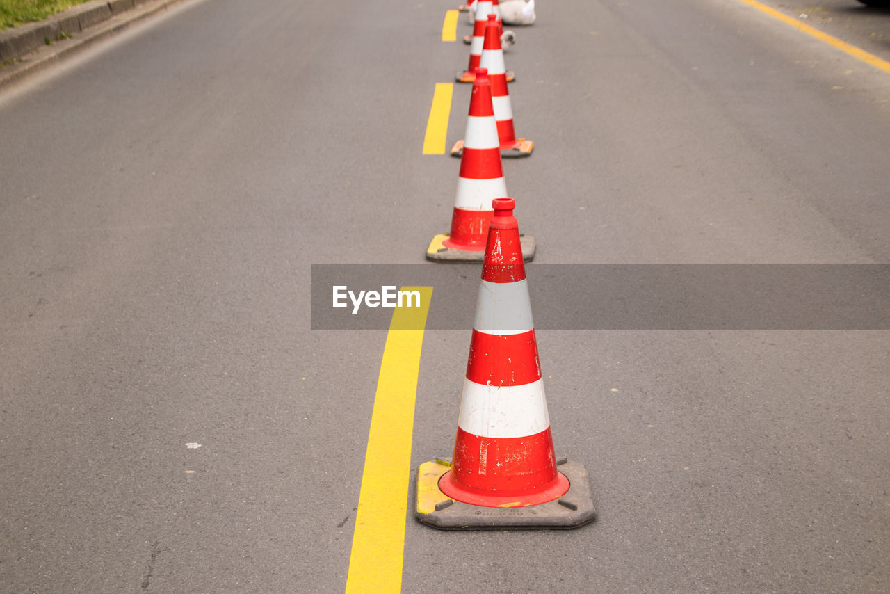 HIGH ANGLE VIEW OF ROAD SIGNS ON STREET