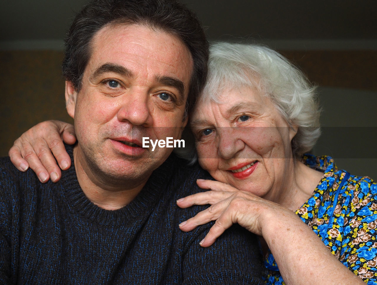 Close-up portrait of mother with son at home