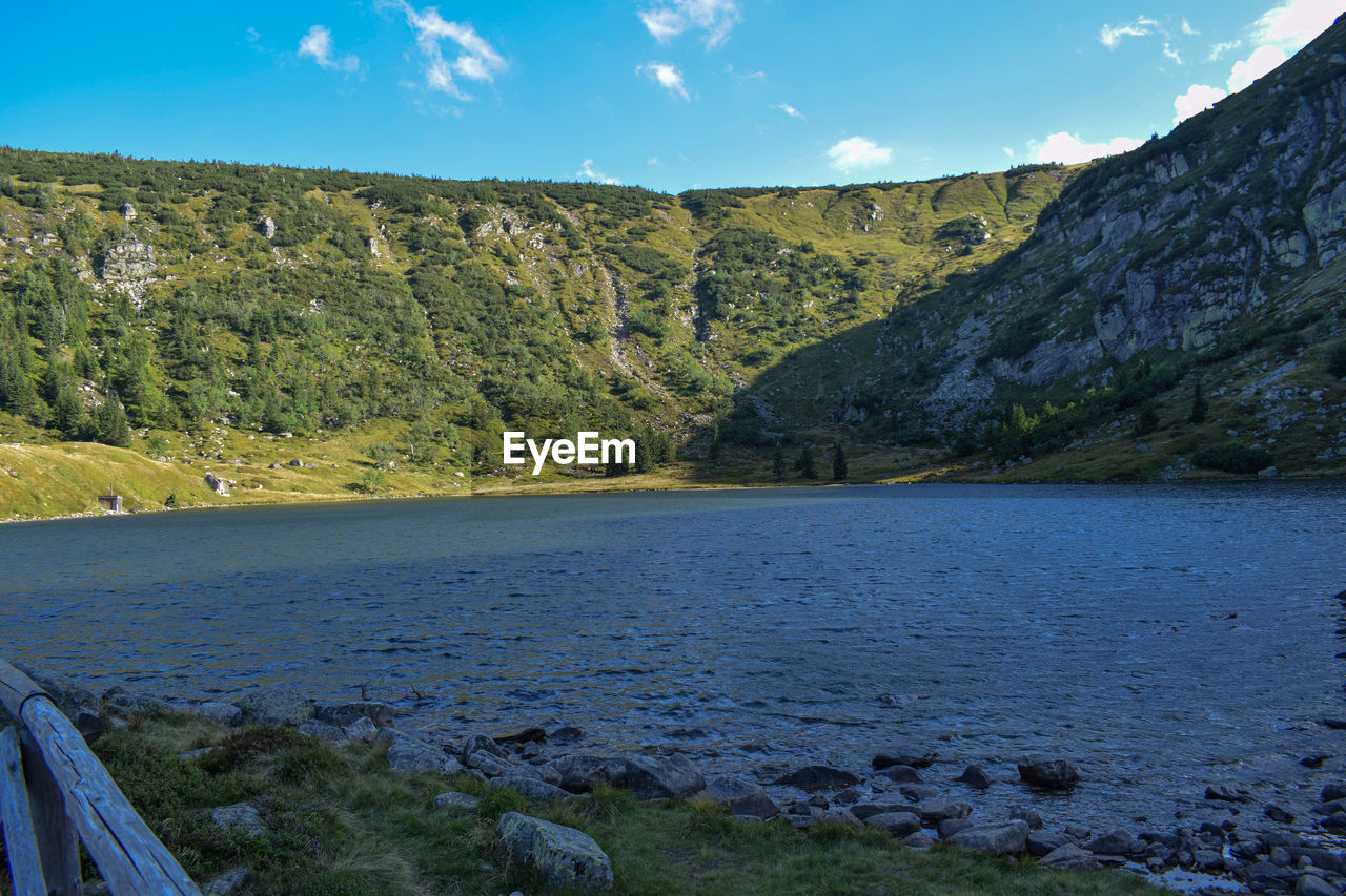 Scenic view of land and mountains against sky