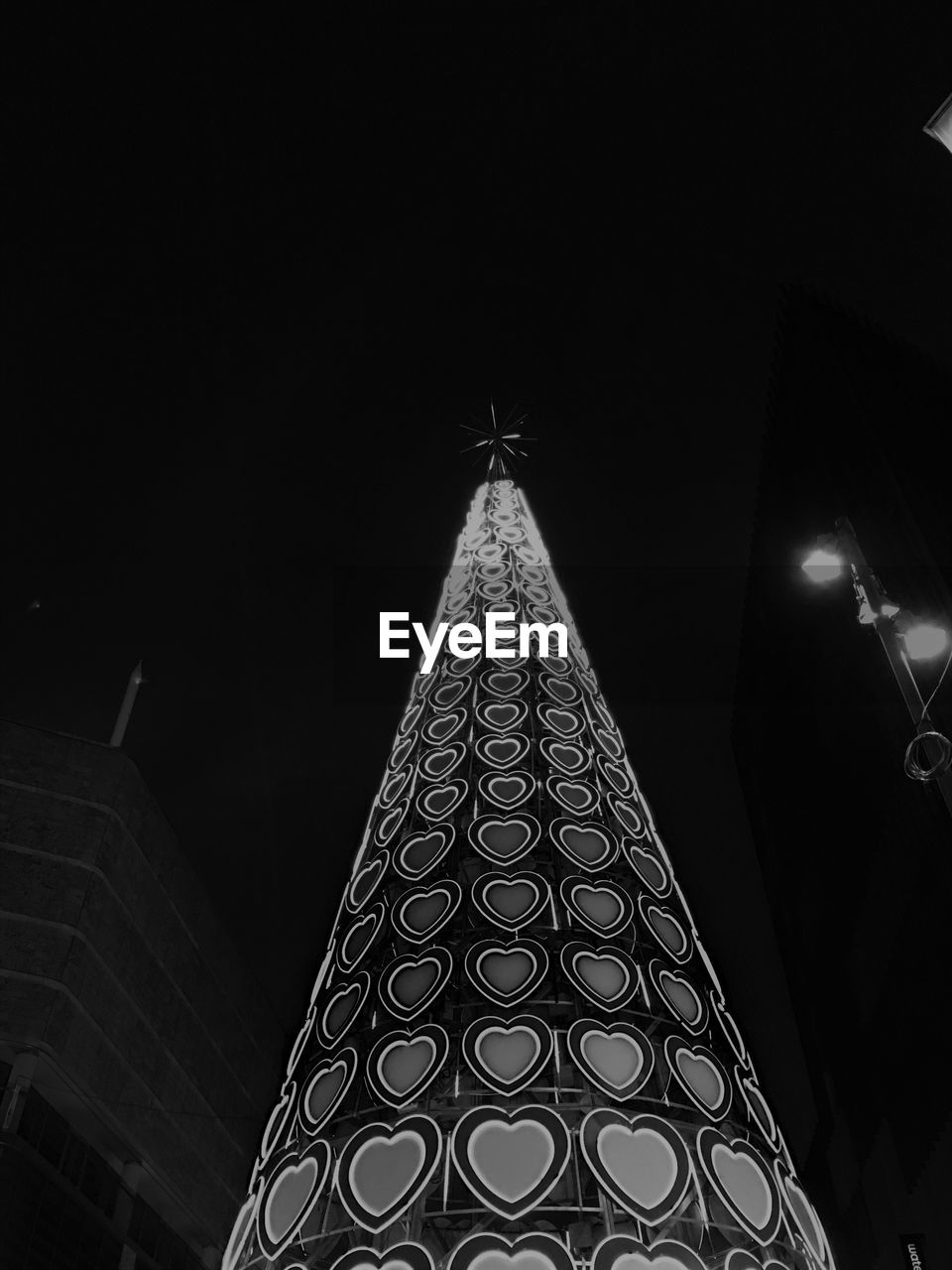 LOW ANGLE VIEW OF CHRISTMAS TREE AGAINST SKY AT NIGHT