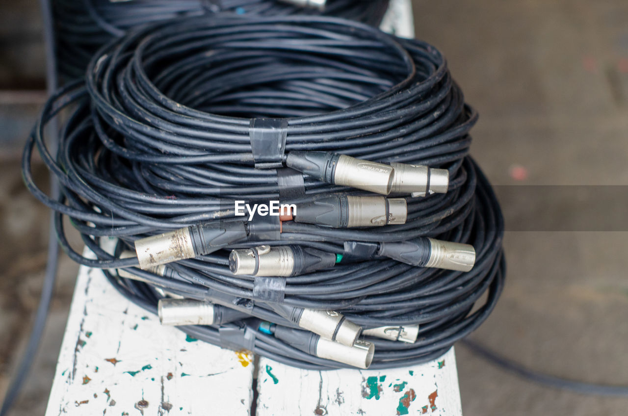 Stack of black cables on table