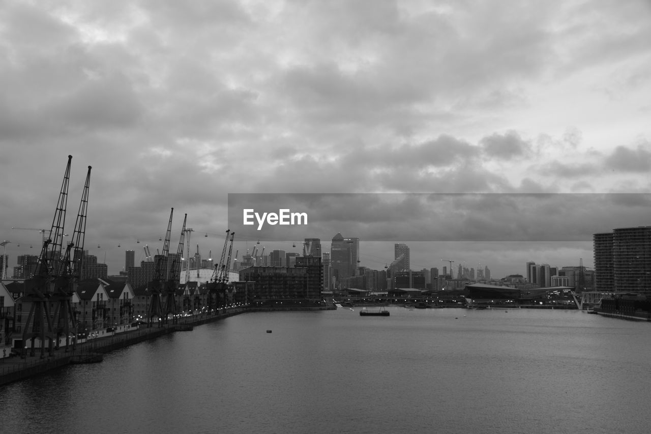 SCENIC VIEW OF RIVER BY CITY AGAINST SKY