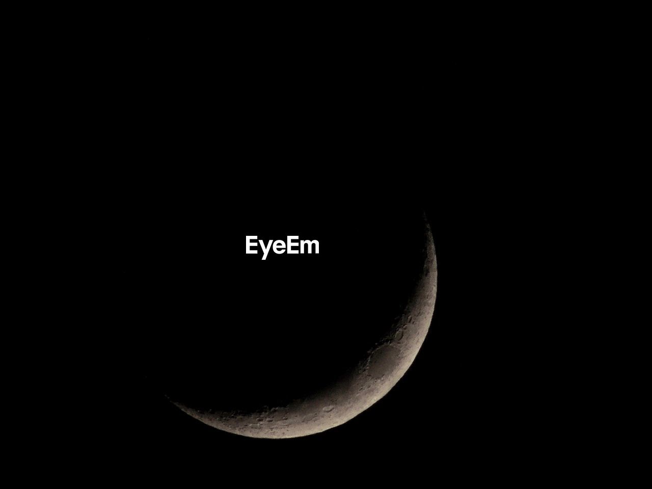 LOW ANGLE VIEW OF HALF MOON IN SKY AT NIGHT