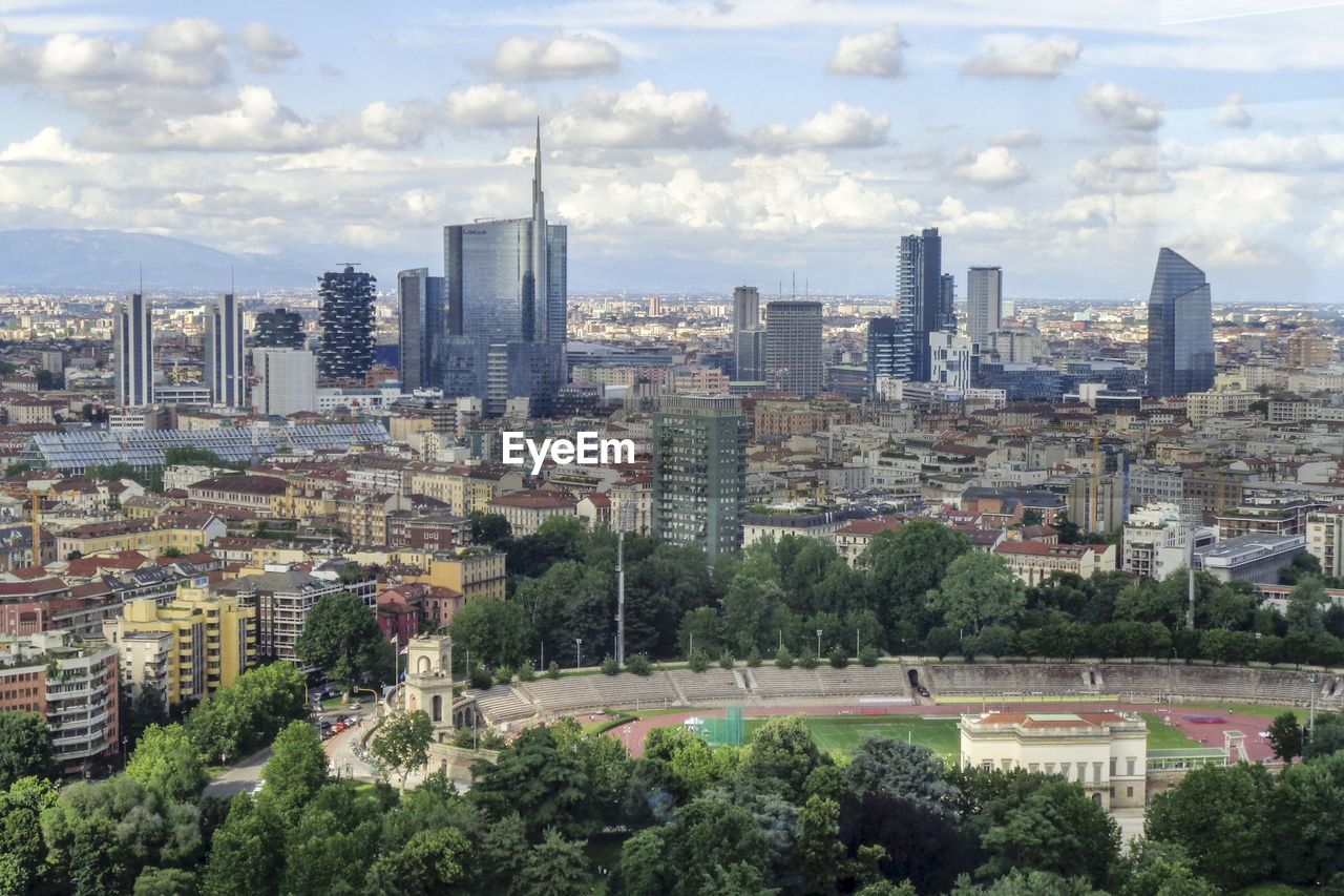 View of cityscape against cloudy sky