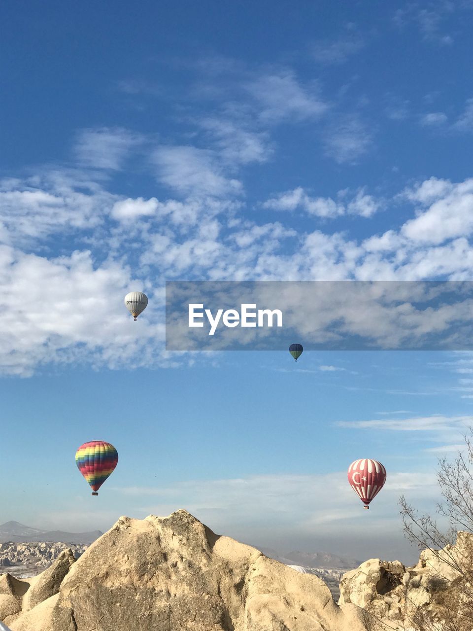 HOT AIR BALLOON FLYING OVER ROCKS