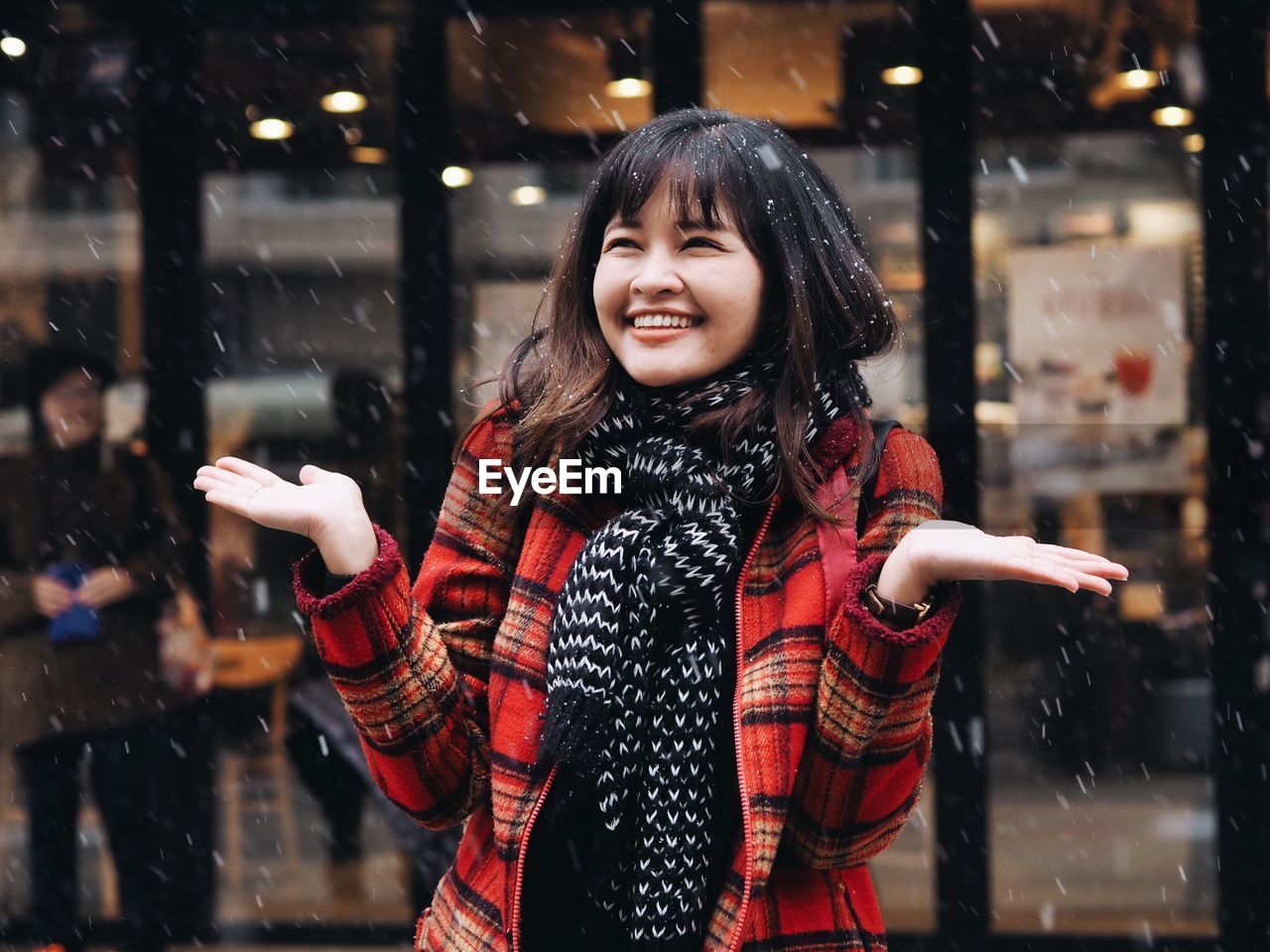 Smiling young woman enjoying during winter