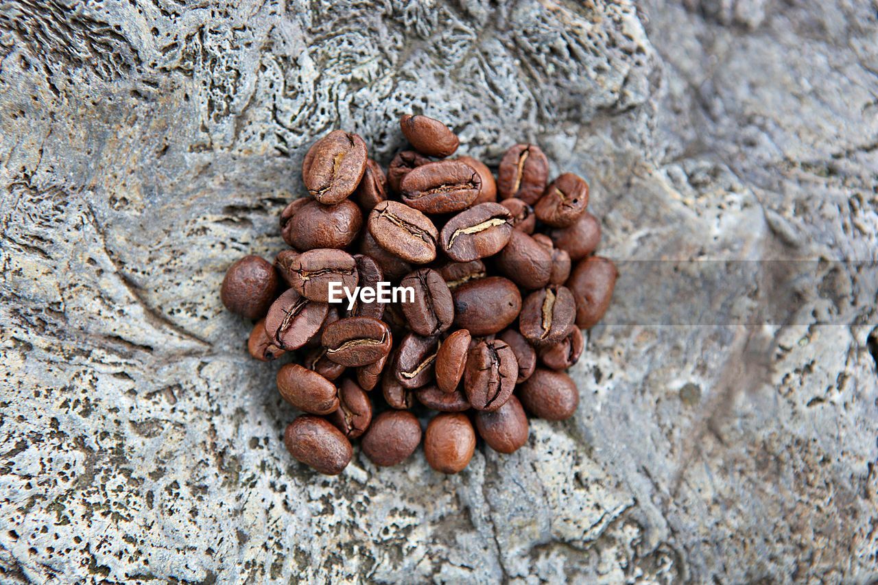 HIGH ANGLE VIEW OF COFFEE BEANS IN GLASS ON WALL