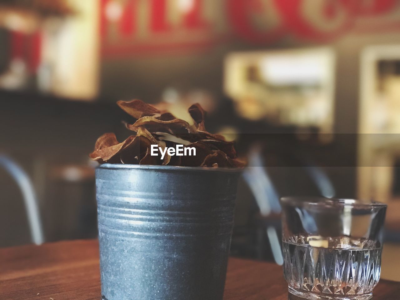 CLOSE-UP OF DRINK IN GLASS ON TABLE