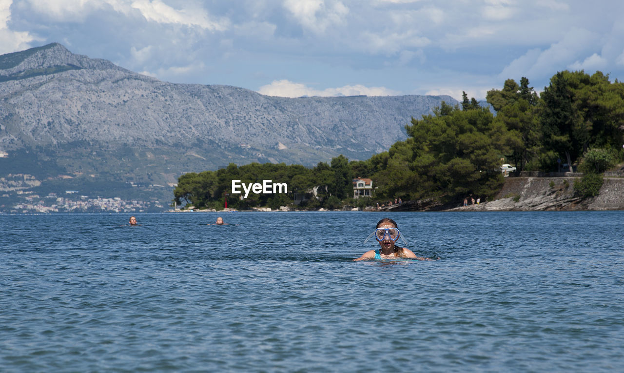 People swimming in sea