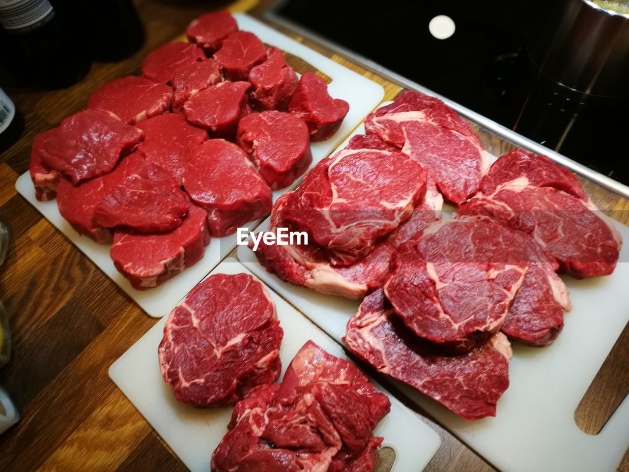 High angle view of different cuts of meat in plate on table