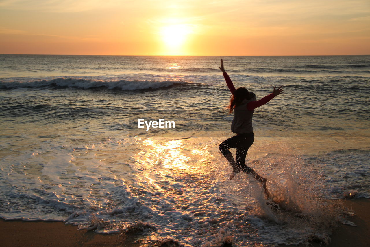 PEOPLE ON BEACH AT SUNSET