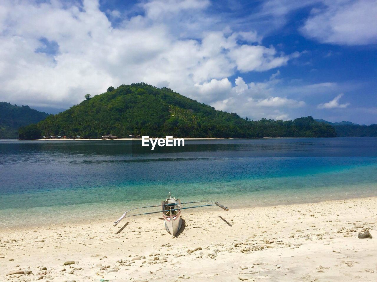 MAN ON BEACH AGAINST SKY