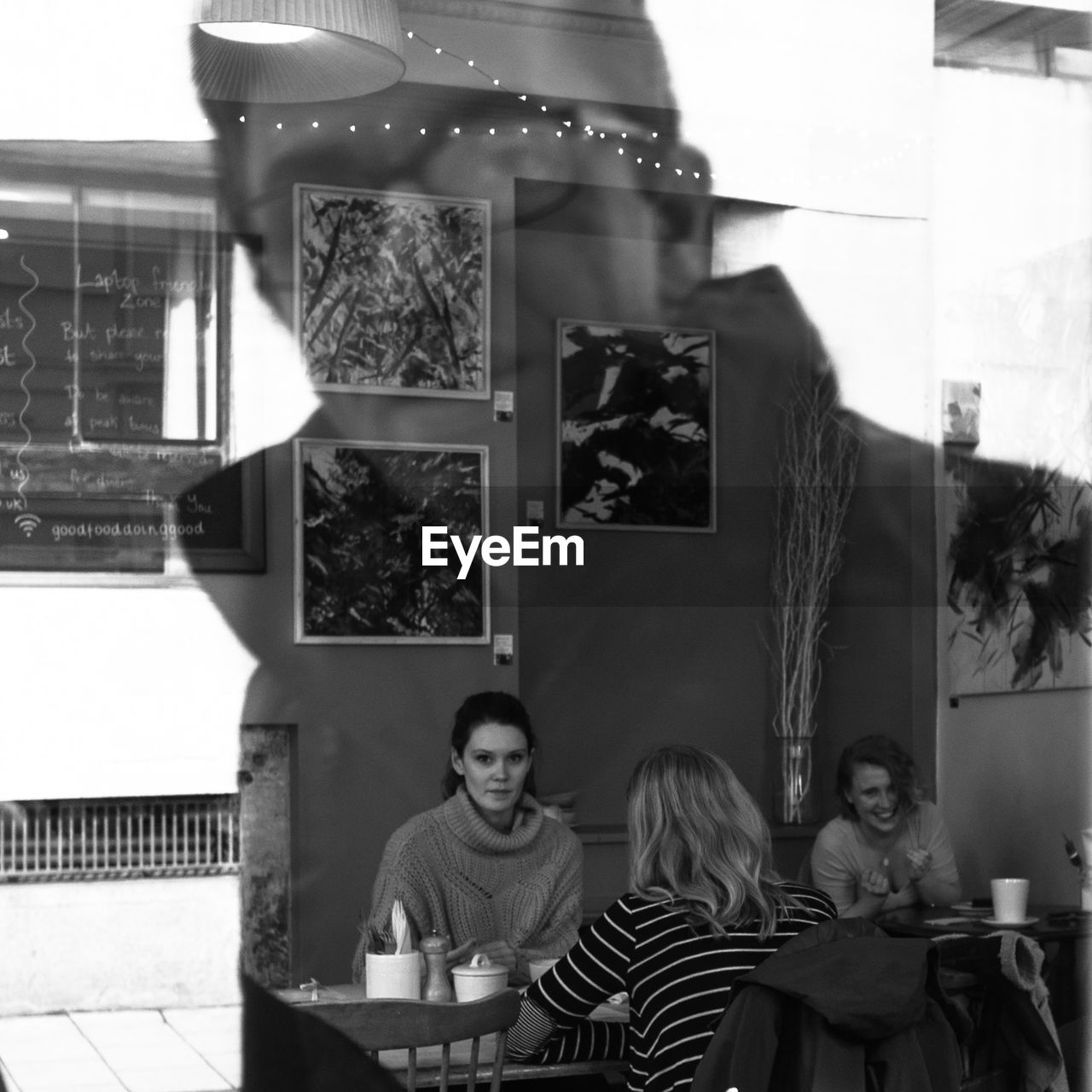 PORTRAIT OF COUPLE SITTING AT TABLE