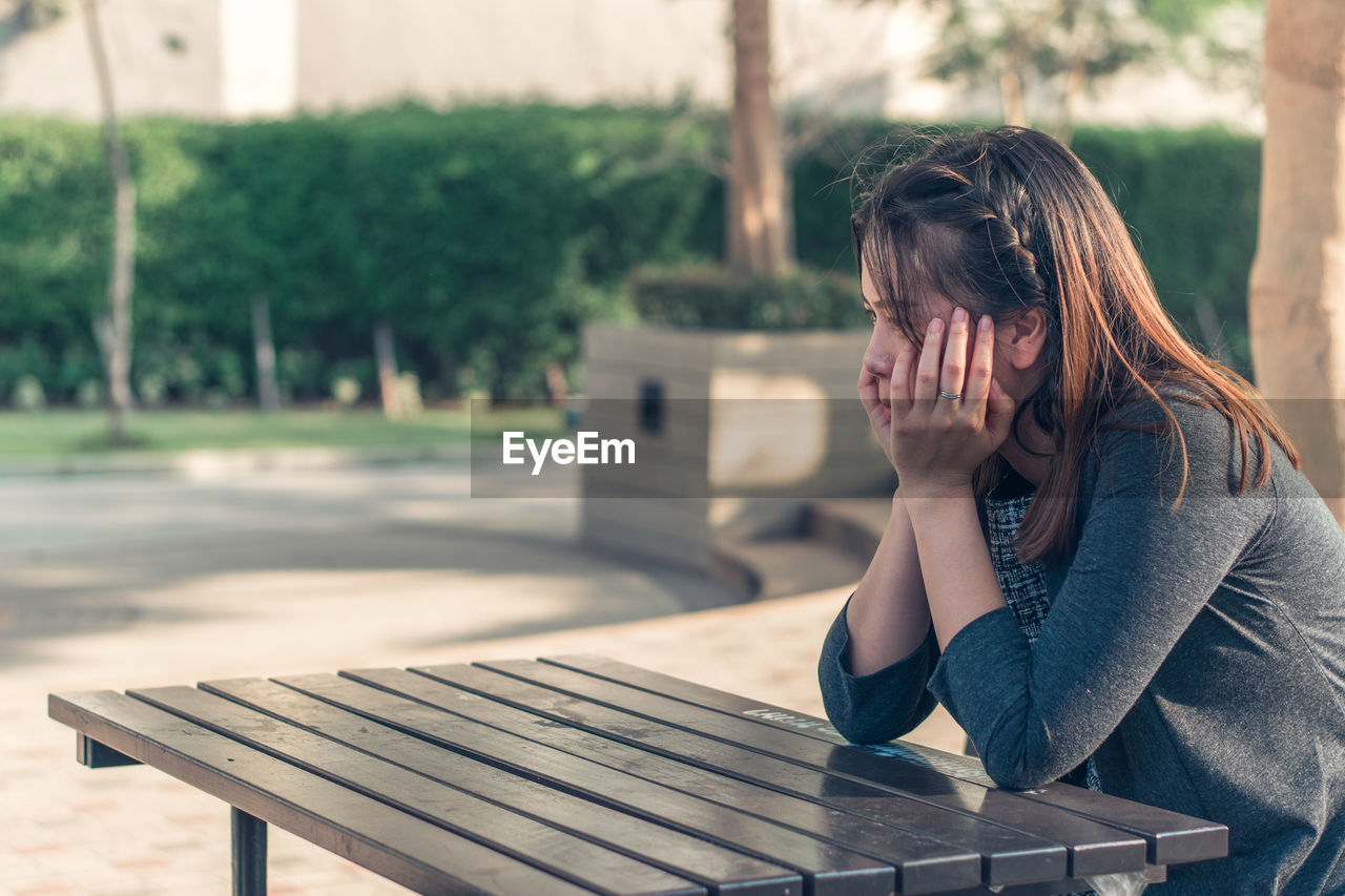 Close-up of sad woman on table