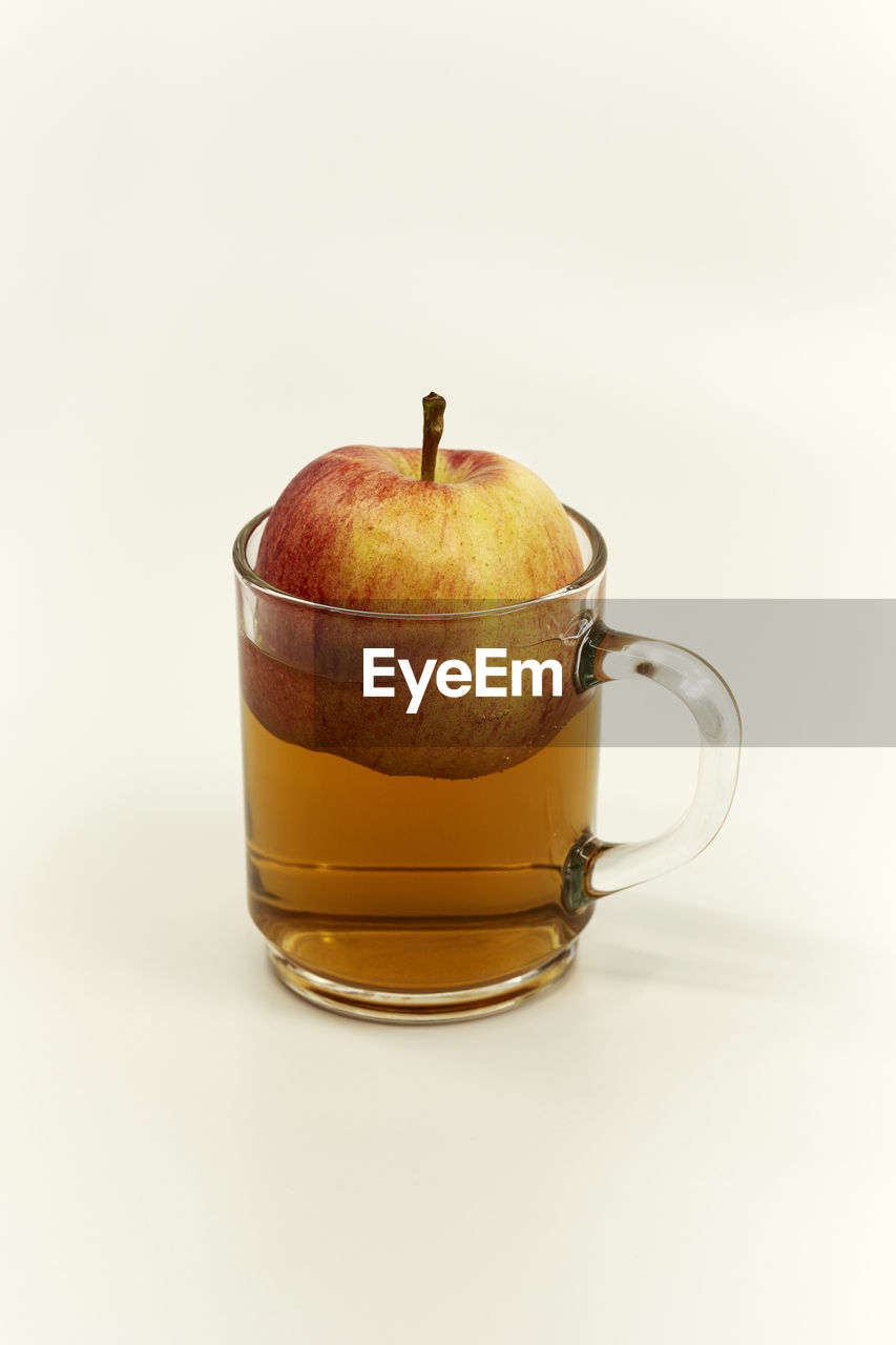 Close-up of drink on table against white background