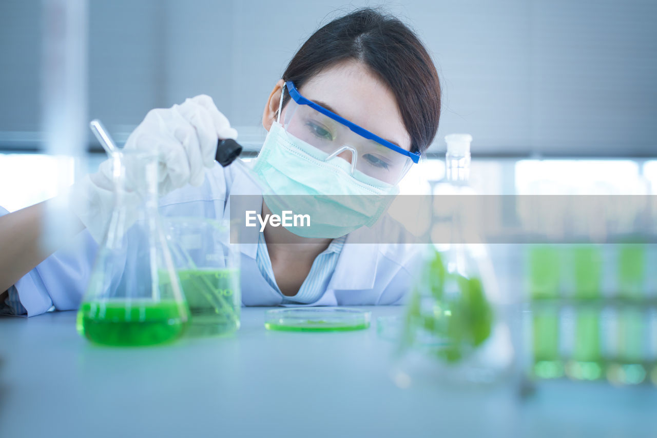 Close-up of female scientist experimenting in laboratory