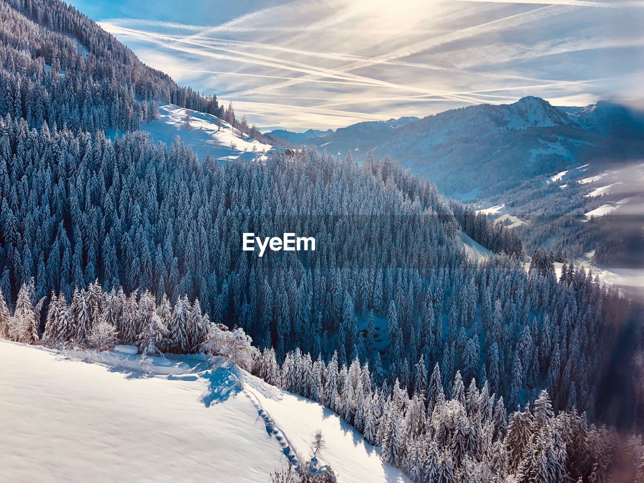 Scenic view of snow covered mountains against sky