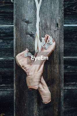 Ballet shoes hanging from wooden wall ID 79368001