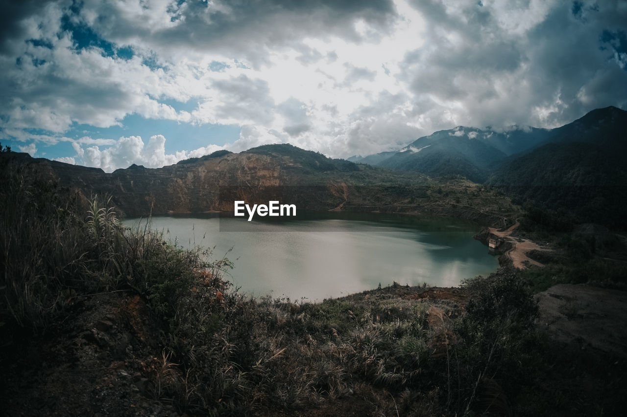 Scenic view of lake and mountains against sky