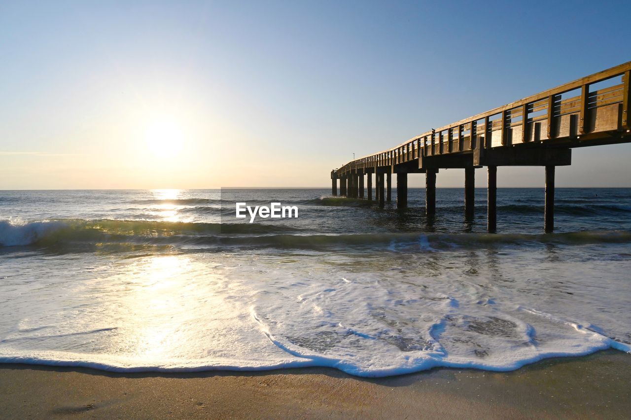 Pier over sea against clear sky