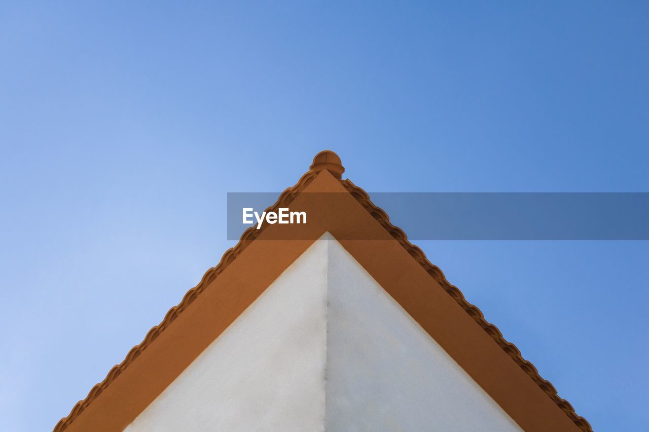 Low angle view of building against clear blue sky