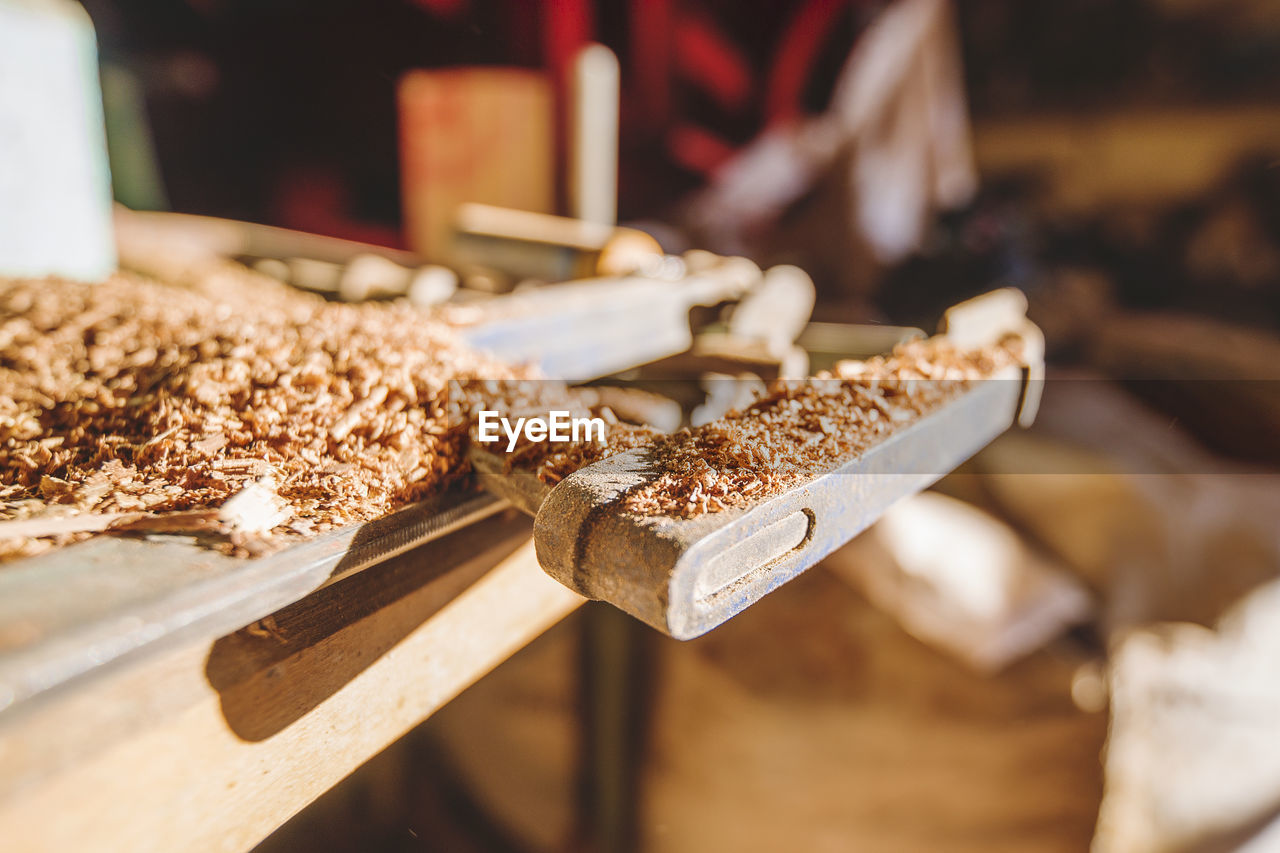 Close-up of wood shavings on table at workshop