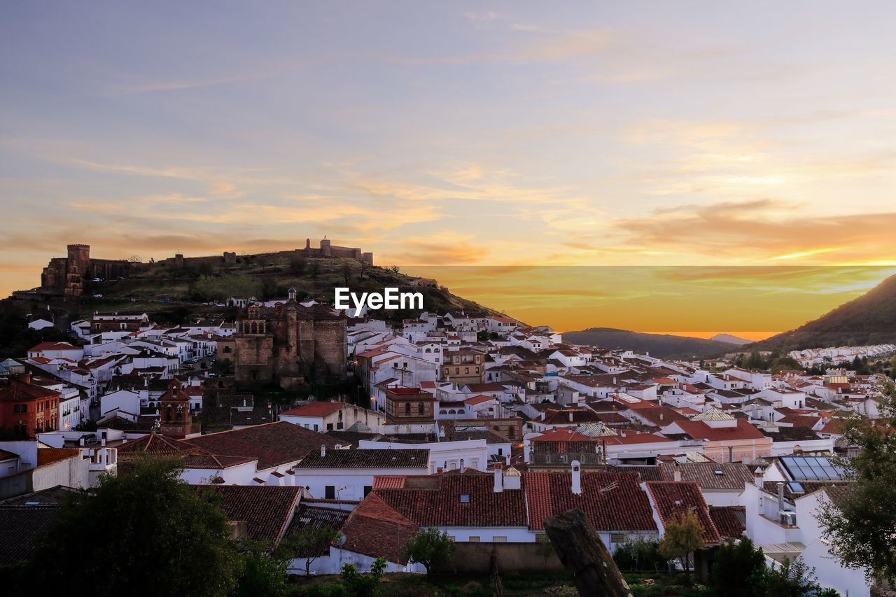 Aerial view of town against sky during sunset