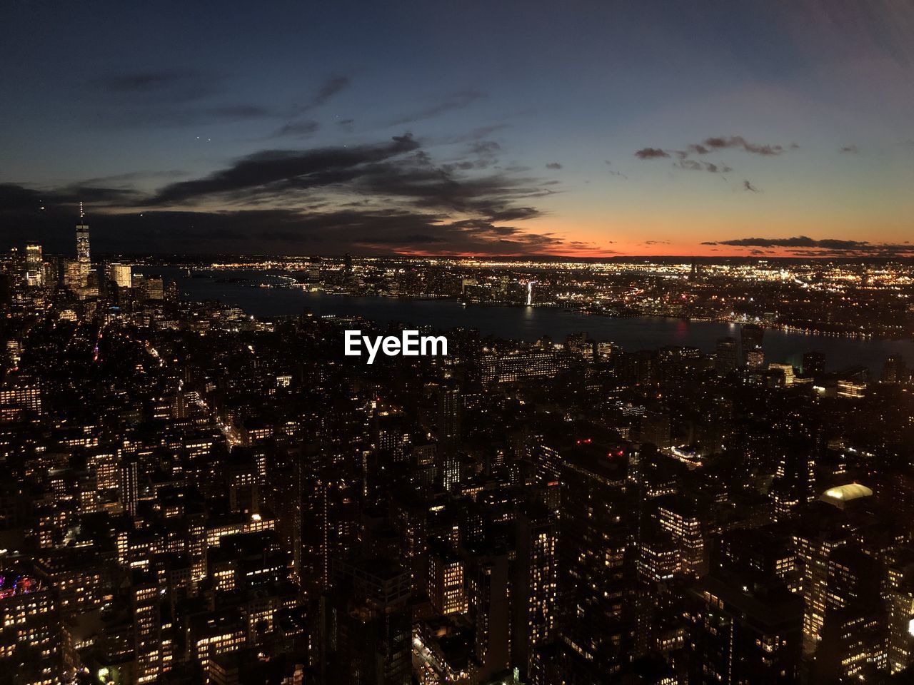 High angle view of illuminated city against sky at night