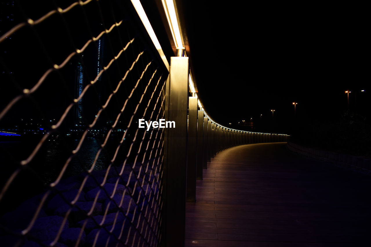 ILLUMINATED FOOTBRIDGE AT NIGHT