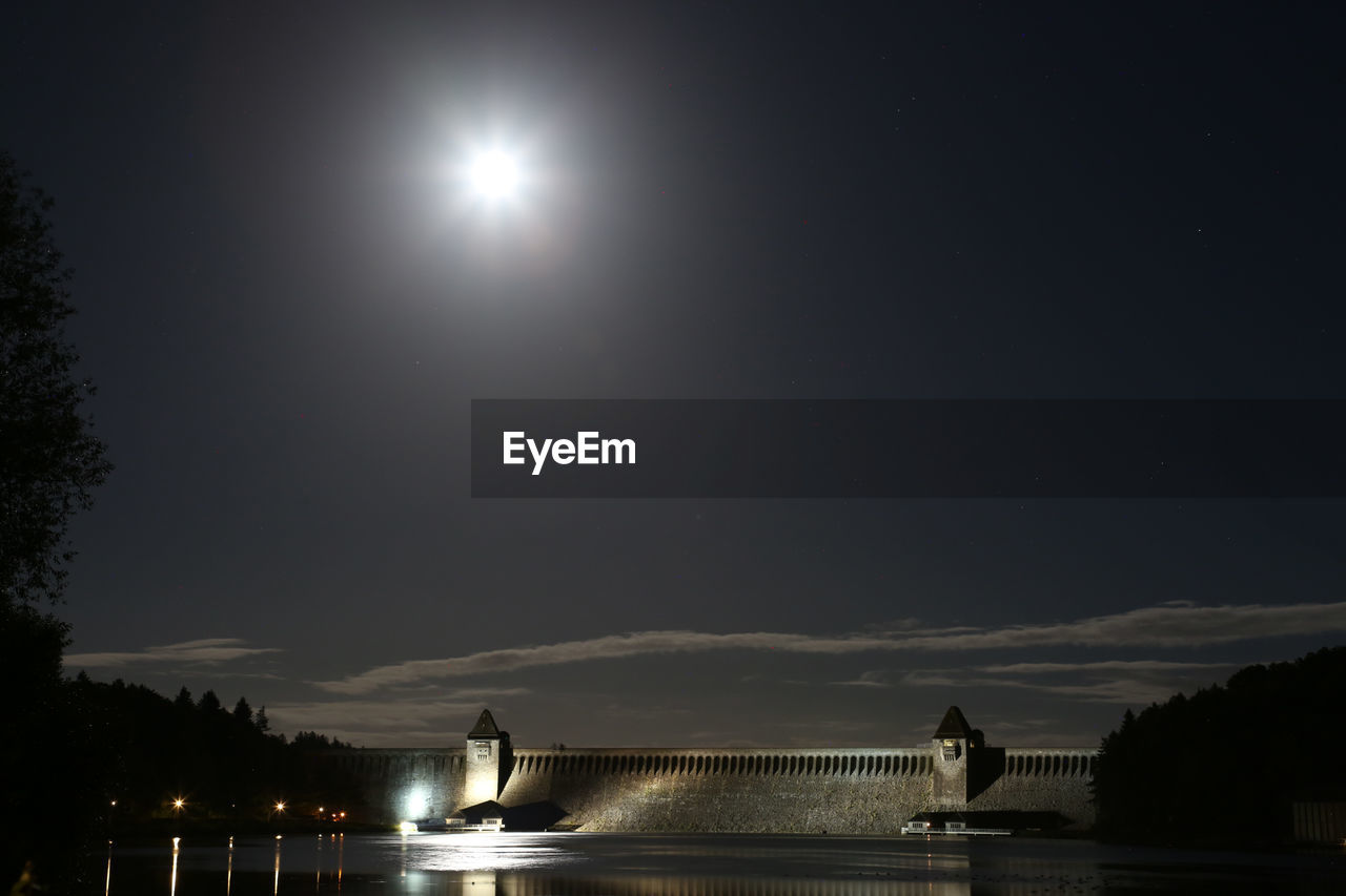 Scenic view of lake against sky at night