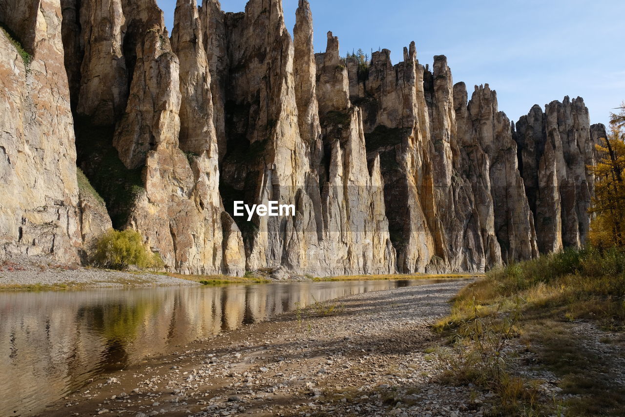 Rock formation amidst trees against sky