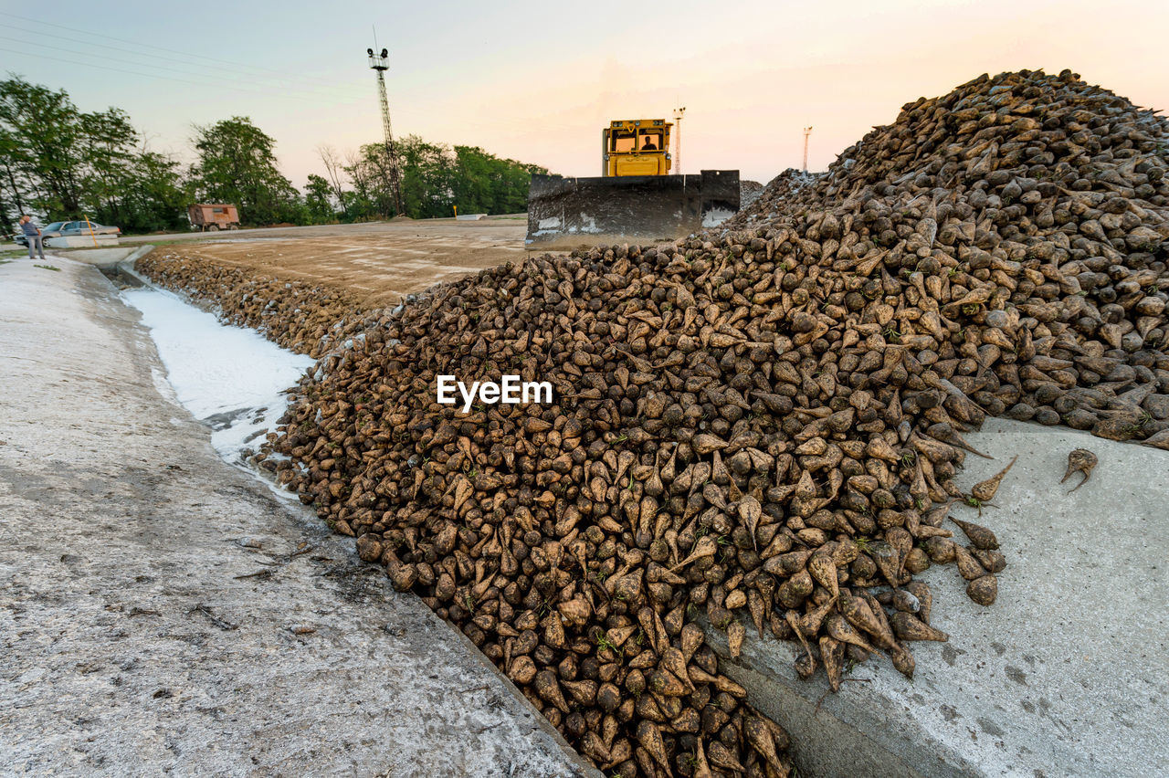 Earth mover at construction site against sky