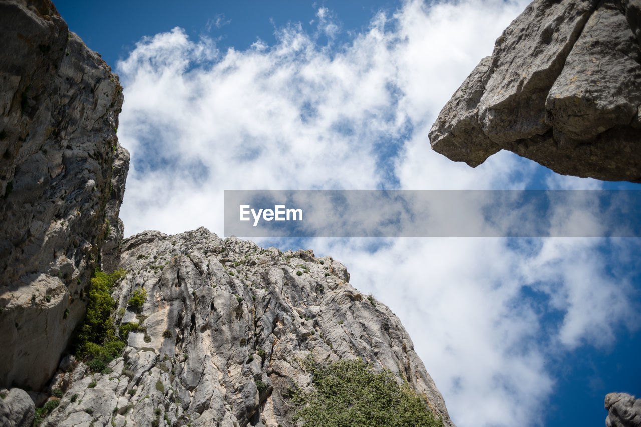 Low angle shot of the sky with clouds and limestone mountains in andalusia.