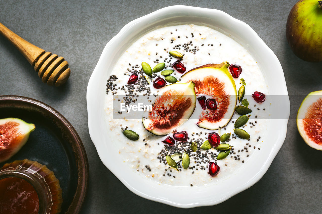 food and drink, food, healthy eating, fruit, wellbeing, common fig, freshness, produce, plant, plate, dish, meal, high angle view, no people, seed, pomegranate, indoors, bowl, citrus fruit, table, slice, still life, directly above, fig, breakfast, studio shot, eating utensil