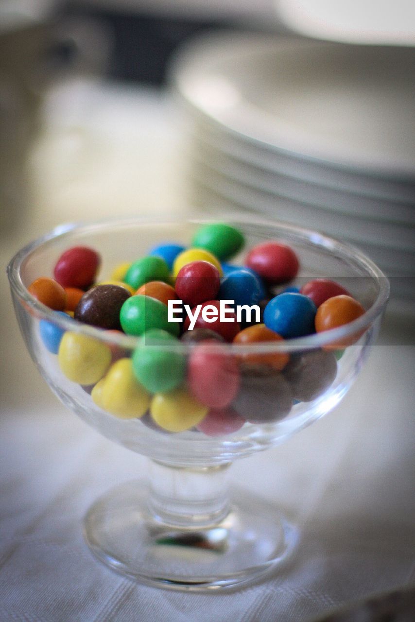 Gumballs in glass on table