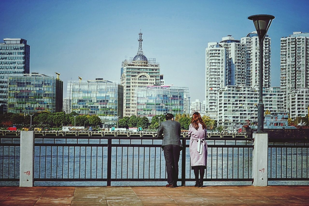 PEOPLE IN FRONT OF CITYSCAPE