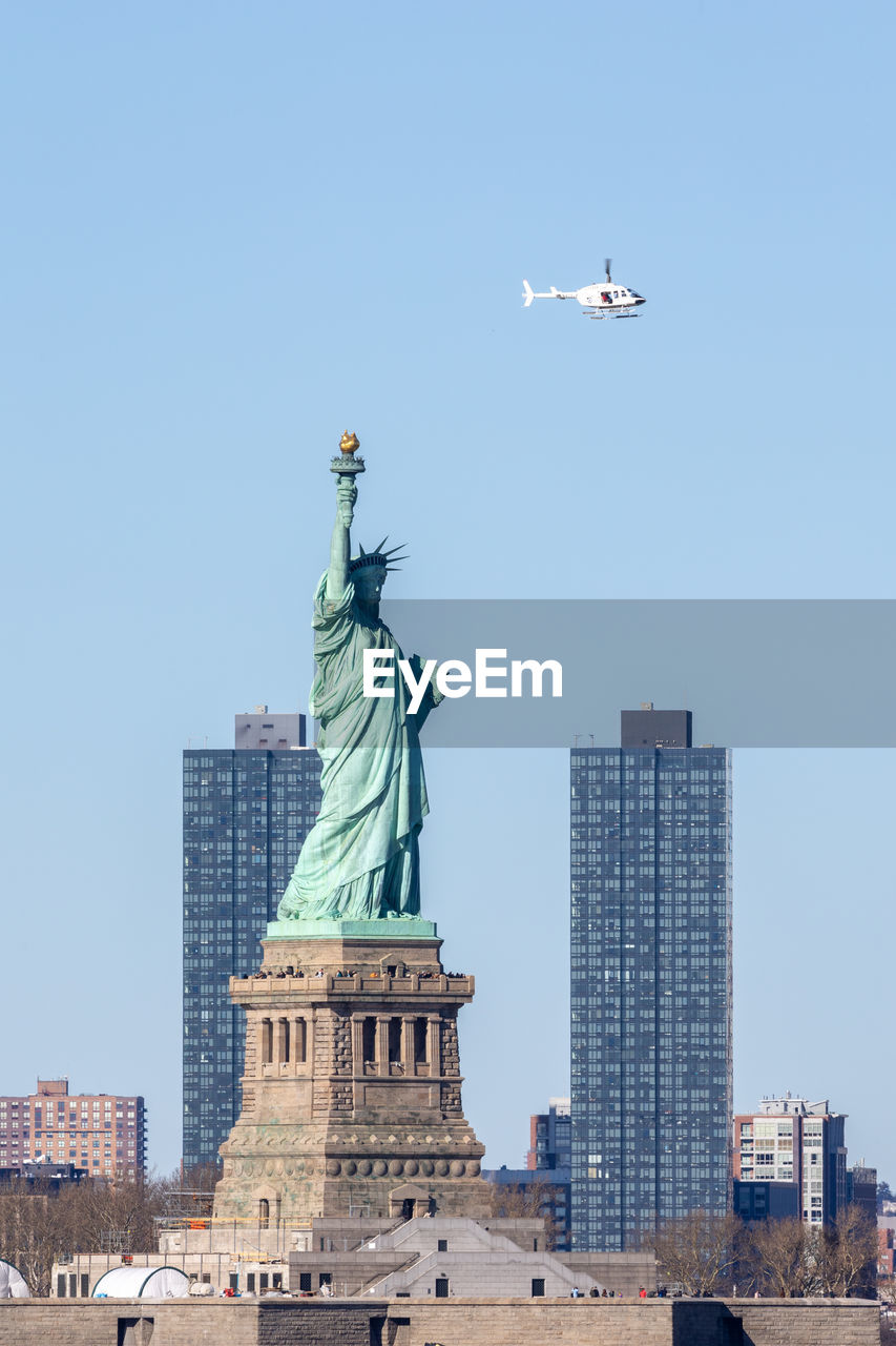 Statue of liberty with jersey city in the background