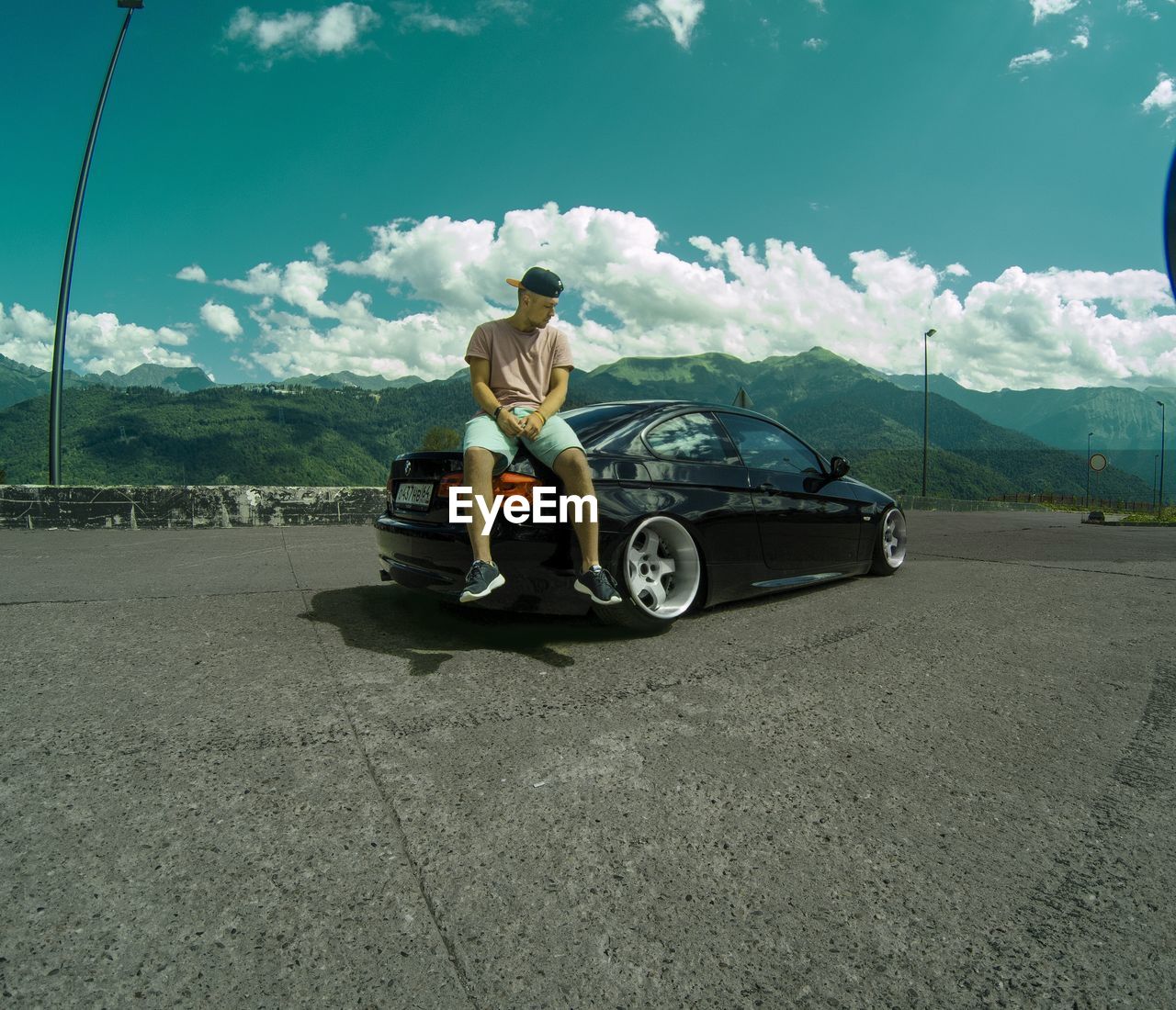 MAN SITTING ON ROAD