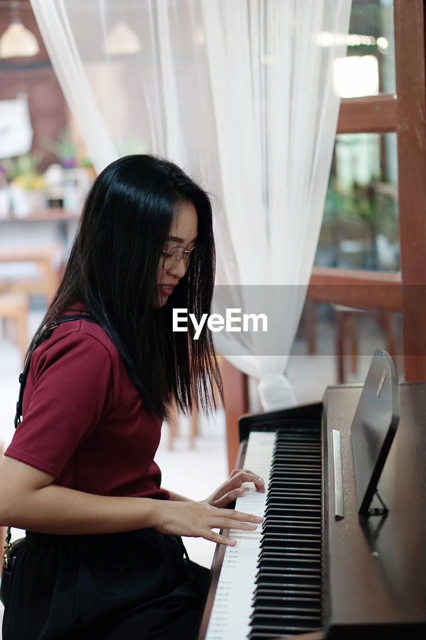 Young woman playing piano