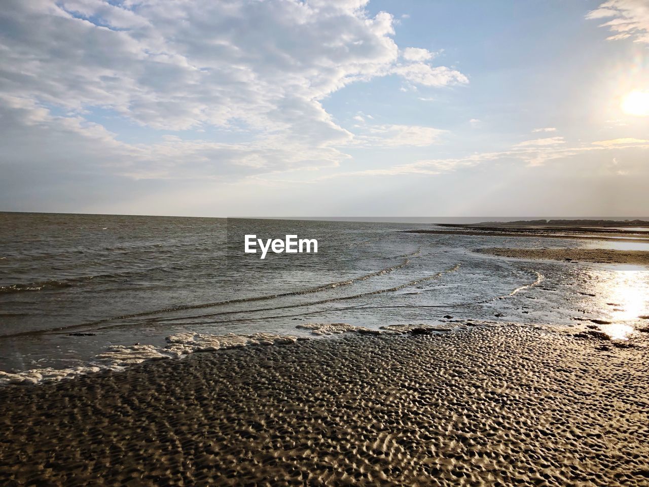 SCENIC VIEW OF BEACH AGAINST SKY DURING SUNSET