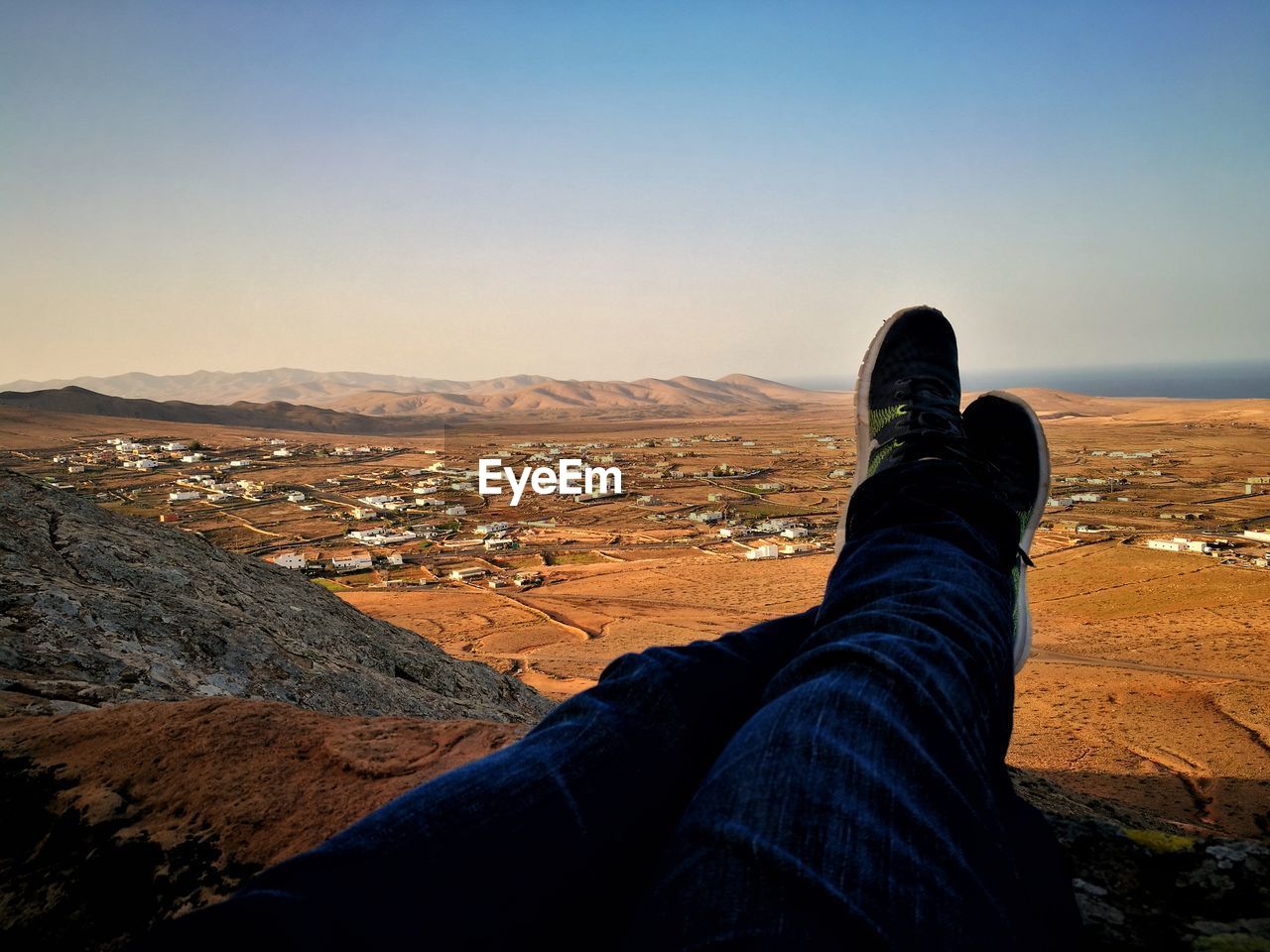 Low section of man relaxing against landscape