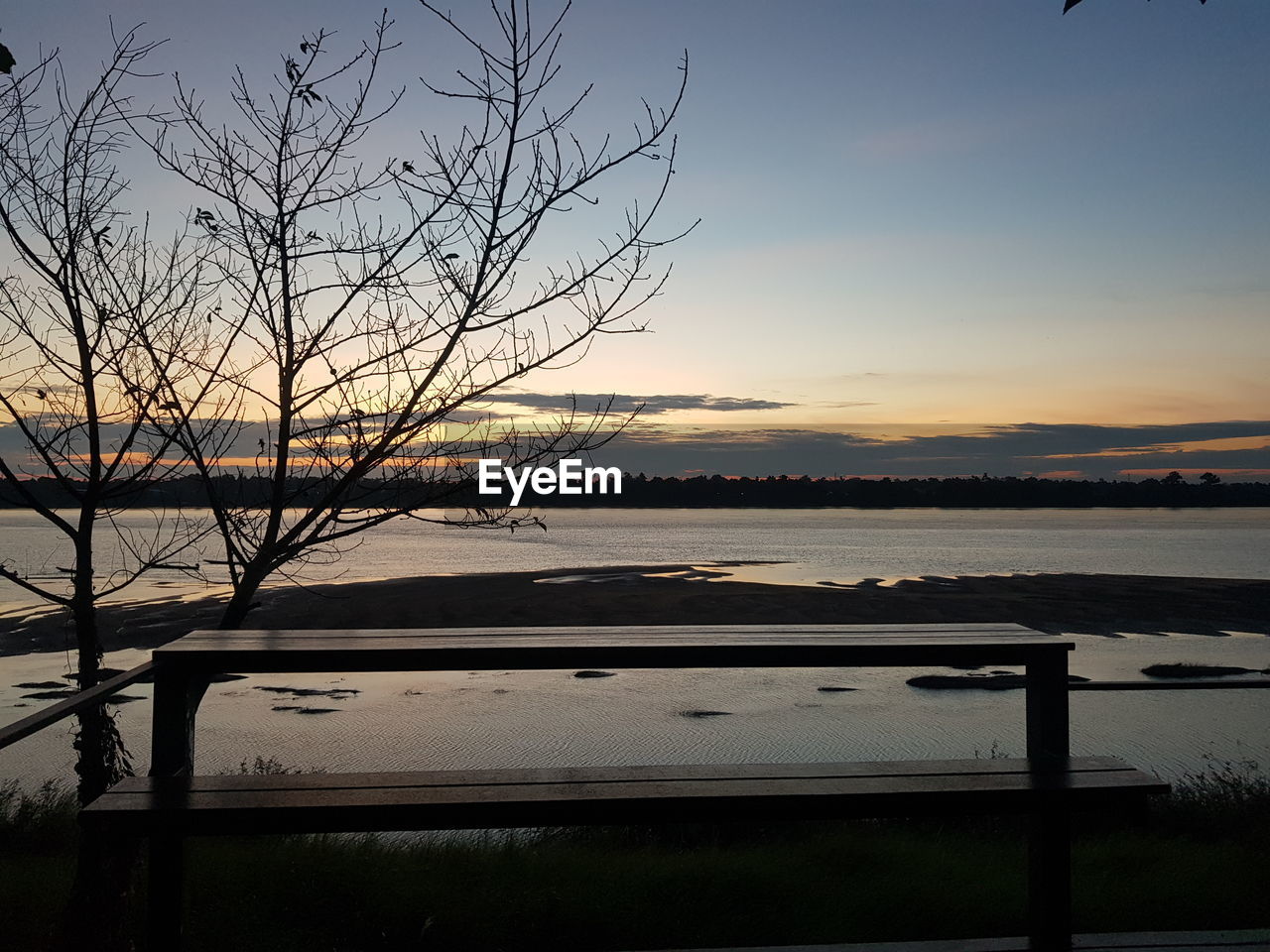 SCENIC VIEW OF LAKE AGAINST ORANGE SKY