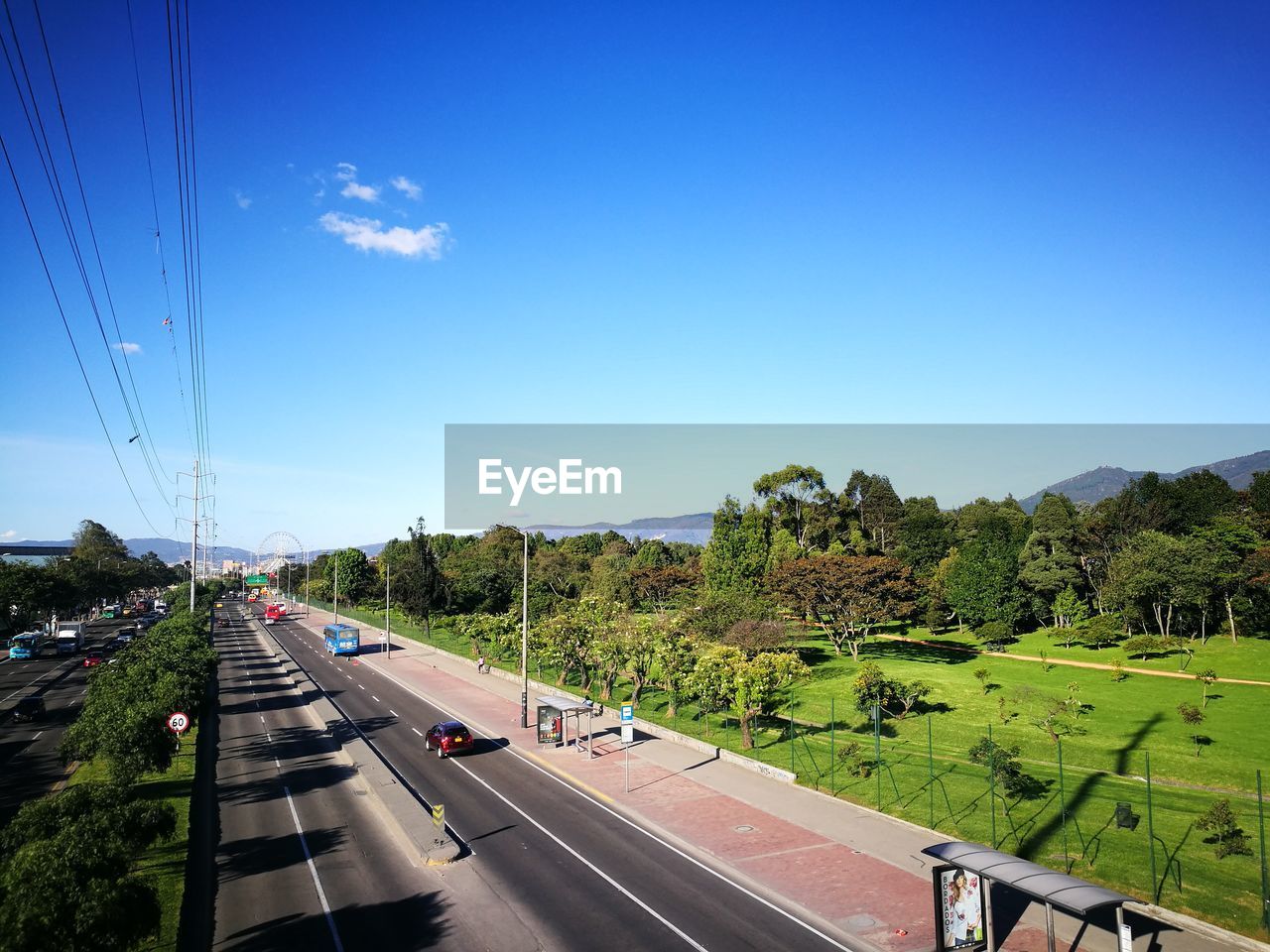 Cars on road against sky in city